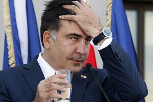 Georgia's President Mikheil Saakashvili reacts during a joint news conference with NATO Secretary General Anders Fogh Rasmussen in Tbilisi, June 27, 2013. REUTERS/Shakh Aivazov/Pool (GEORGIA - Tags: POLITICS MILITARY) - RTX113AY